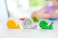 Cute little girl having fun with modeling clay at a daycare. Creative kid molding at home. Royalty Free Stock Photo