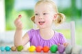 Cute little girl having fun with modeling clay at a daycare. Creative kid molding at home. Royalty Free Stock Photo