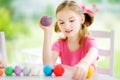 Cute little girl having fun with modeling clay at a daycare. Creative kid molding at home. Royalty Free Stock Photo