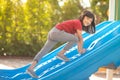 Cute little girl having fun on a playground outdoors in summer Royalty Free Stock Photo