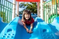 Cute little girl having fun on a playground outdoors in summer Royalty Free Stock Photo