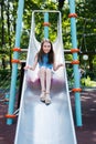 Cute little girl having fun on a playground outdoors on a sunny summer day. summer vacation Royalty Free Stock Photo