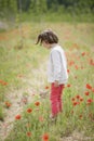 Cute little girl having fun in a poppy field Royalty Free Stock Photo