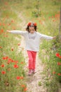 Cute little girl having fun in a poppy field Royalty Free Stock Photo