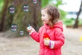 Cute little girl having fun with soap bubbles Royalty Free Stock Photo