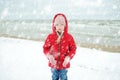 Cute little girl having fun at winter beach on cold winter day. Kids playing by the ocean Royalty Free Stock Photo