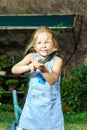 Cute little girl helping her mother in the backyard Royalty Free Stock Photo