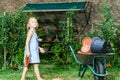 Cute little girl helping her mother in the backyard Royalty Free Stock Photo