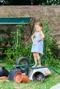 Cute little girl helping her mother in the backyard Royalty Free Stock Photo