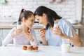 Cute little girl and her mom smiling and touching foreheads