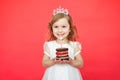 Cute little girl and her birthday cake on red background Royalty Free Stock Photo