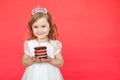 Cute little girl and her birthday cake on red background Royalty Free Stock Photo