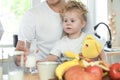 Cute little girl with her father drinking milk over window background