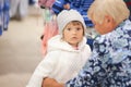 Cute little girl and her grandmother choosing clothes in the shop. Royalty Free Stock Photo