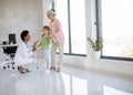 Cute little girl with her grandmother at the pediatrician examination Royalty Free Stock Photo