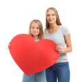 Cute little girl and her mother with big red paper heart on white background Royalty Free Stock Photo