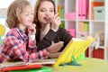 Cute little girl with her mother doing homework Royalty Free Stock Photo