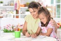 Cute little girl with her mother doing homework Royalty Free Stock Photo