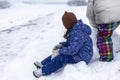 Cute little girl and her mother playing in snow on winter day Royalty Free Stock Photo