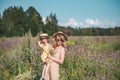 Cute little girl with her mother walking in the flowers field Royalty Free Stock Photo