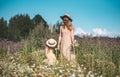 Cute little girl with her mother walking in the flowers field Royalty Free Stock Photo