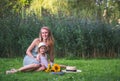 Cute little girl with her mother walking in the park, sunflowers Royalty Free Stock Photo