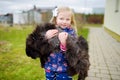 Cute little girl with her pet cat on chilly autumn day Royalty Free Stock Photo