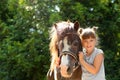 Cute little girl with her pony in park Royalty Free Stock Photo