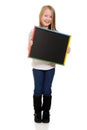 Cute little girl holding blackboard