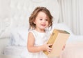 Cute little girl is holding a book in her hands. Royalty Free Stock Photo