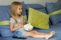 Little girl watching TV. Happy cute little girl holding a bowl with popcorn Royalty Free Stock Photo