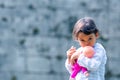 Cute little girl holding and embracing her doll Royalty Free Stock Photo