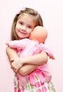 Cute little girl holding and embracing her doll Royalty Free Stock Photo