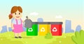 Cute little girl holding garbage plastic bag standing near containers with different types of recycling waste. Segregate Royalty Free Stock Photo