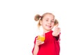Cute little girl holding glass with juice with thumb up Royalty Free Stock Photo