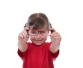 Cute little girl holding glasses and looking thru it