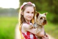 Cute little girl holding her yorkshire terrier dog Royalty Free Stock Photo