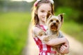 Cute little girl holding her yorkshire terrier dog Royalty Free Stock Photo