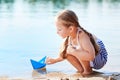 Cute little girl holding origami boat outdoors Royalty Free Stock Photo