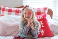Cute little girl holding a peppermint lollipop at Christmastime