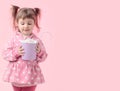 Cute little girl holding small violet bucket of marshmallow