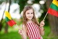 Cute little girl holding tricolor Lithuanian flag