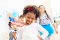 Cute little girl holds a gift and a flag of the USA at the celebration of her birthday. Royalty Free Stock Photo