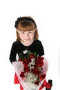 Cute little girl in holiday dress with red roses