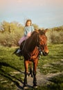 Cute little girl with horse on the grass. Royalty Free Stock Photo