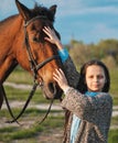 Cute little girl with horse on the grass. Royalty Free Stock Photo