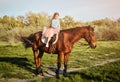 Cute little girl with horse on the grass. Royalty Free Stock Photo