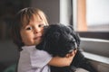 Cute little girl hug and play with her puppy Royalty Free Stock Photo
