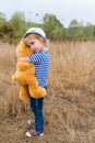 Cute little girl hugging a big Teddy bear