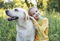 Cute little girl hugging her pet dog - golden labrador retriever Royalty Free Stock Photo